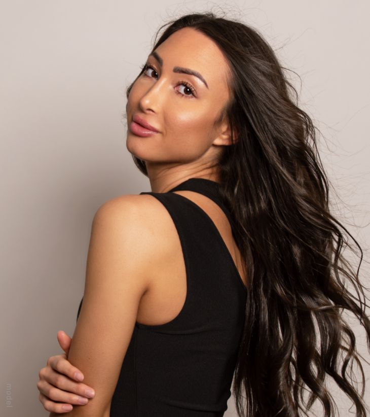 woman looking behind her shoulder