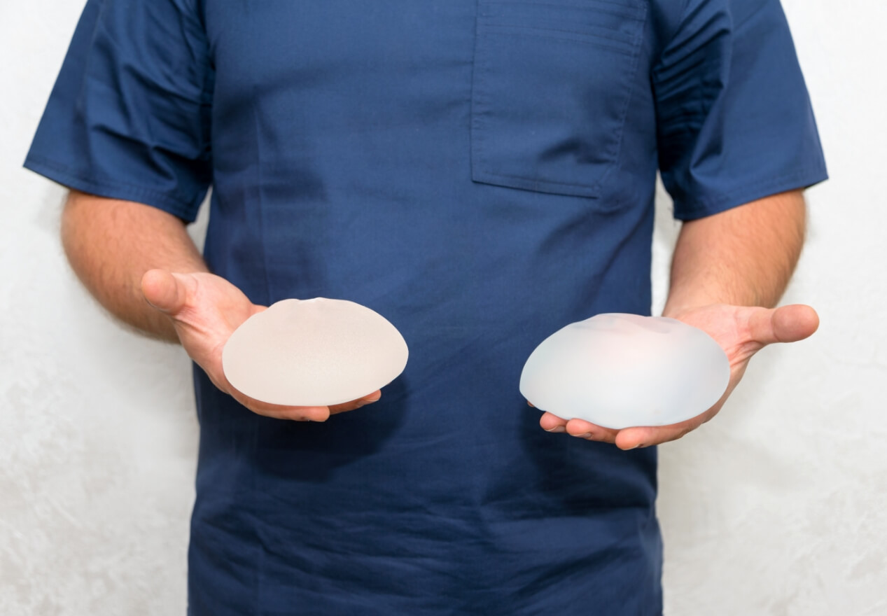 Medical professional holding breast implants