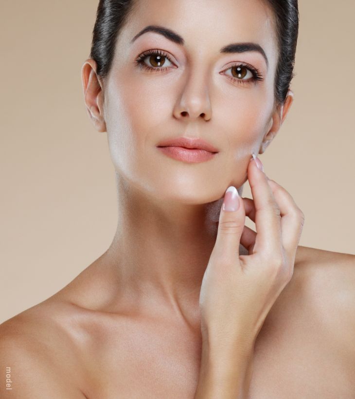 woman with her hand by her cheek and chin